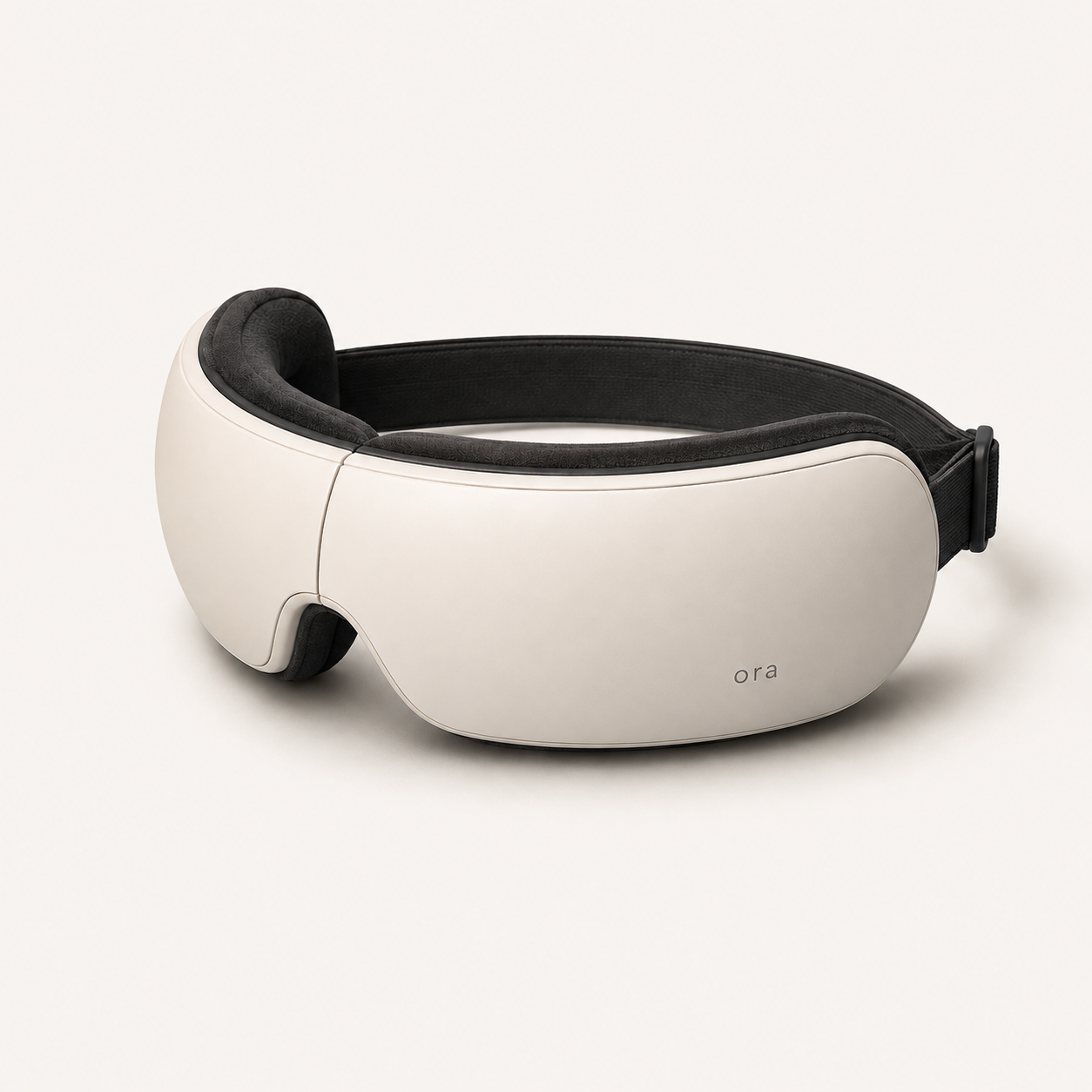 Ora eye massager in Cloud White, three-quarter studio view
